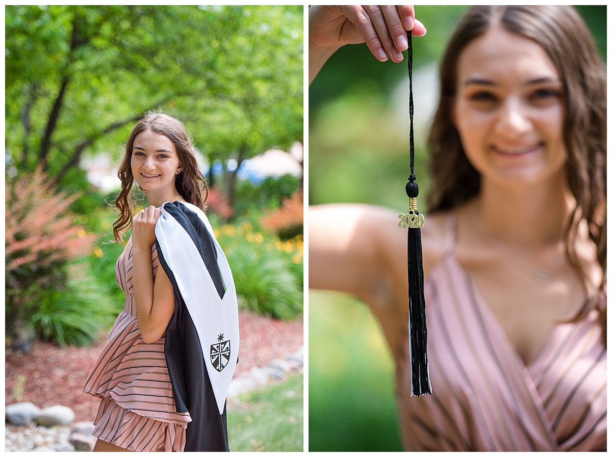 High school senior girl holding out her tassel.
