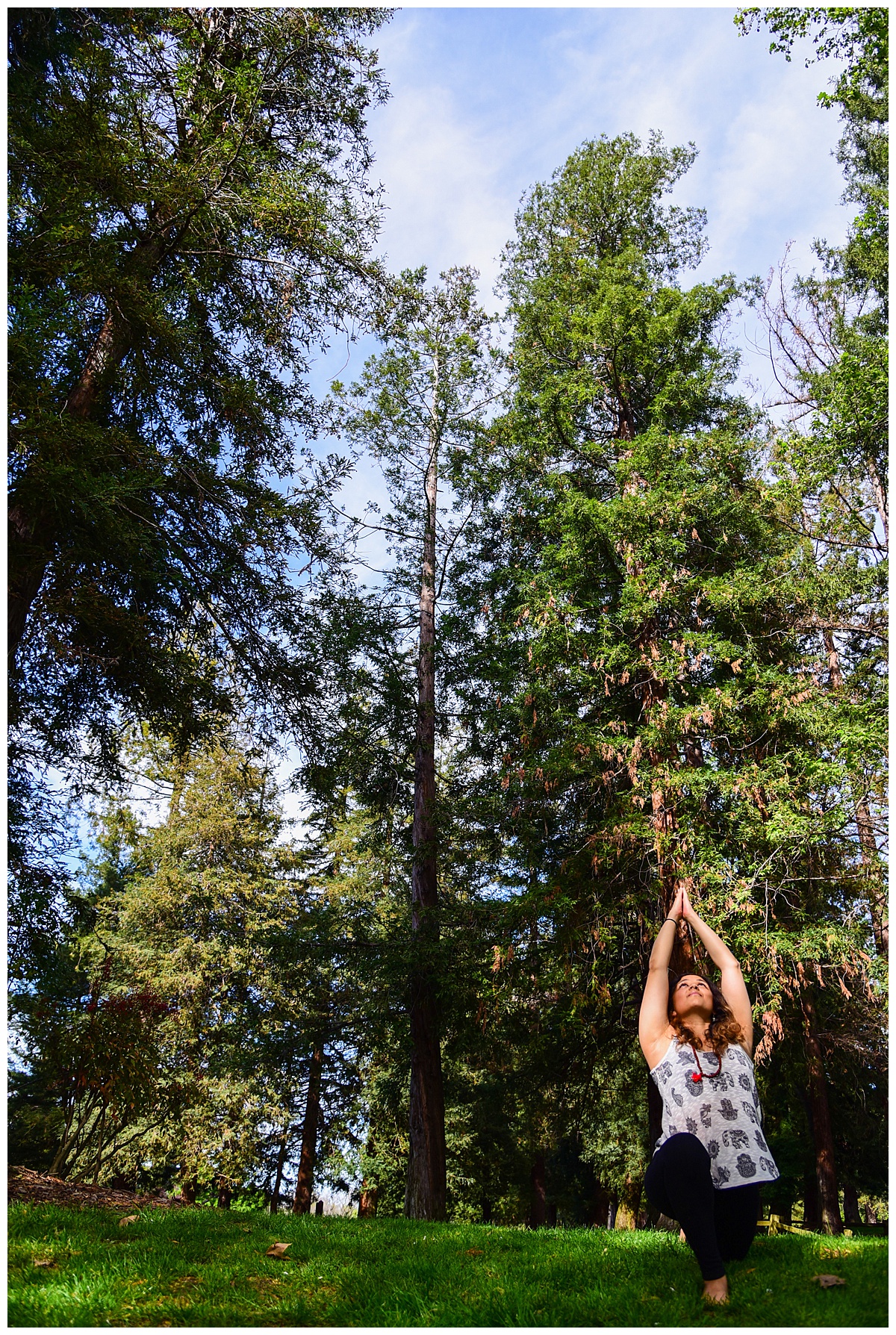 Woman doing yoga in Cuesta Park, Mountain View, CA with redwood trees