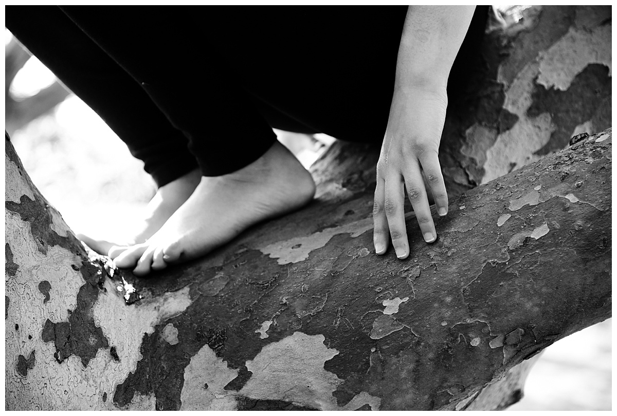yoga instructor's feet and hands, seated in sycamore tree