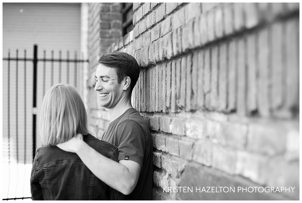 Black and white image of an engaged couple with strong cut to bokeh