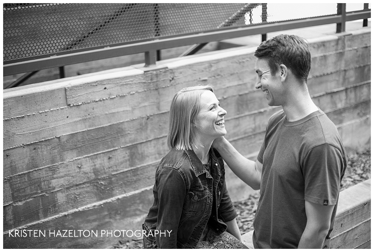 Black and white image of an engaged couple smiling at each other