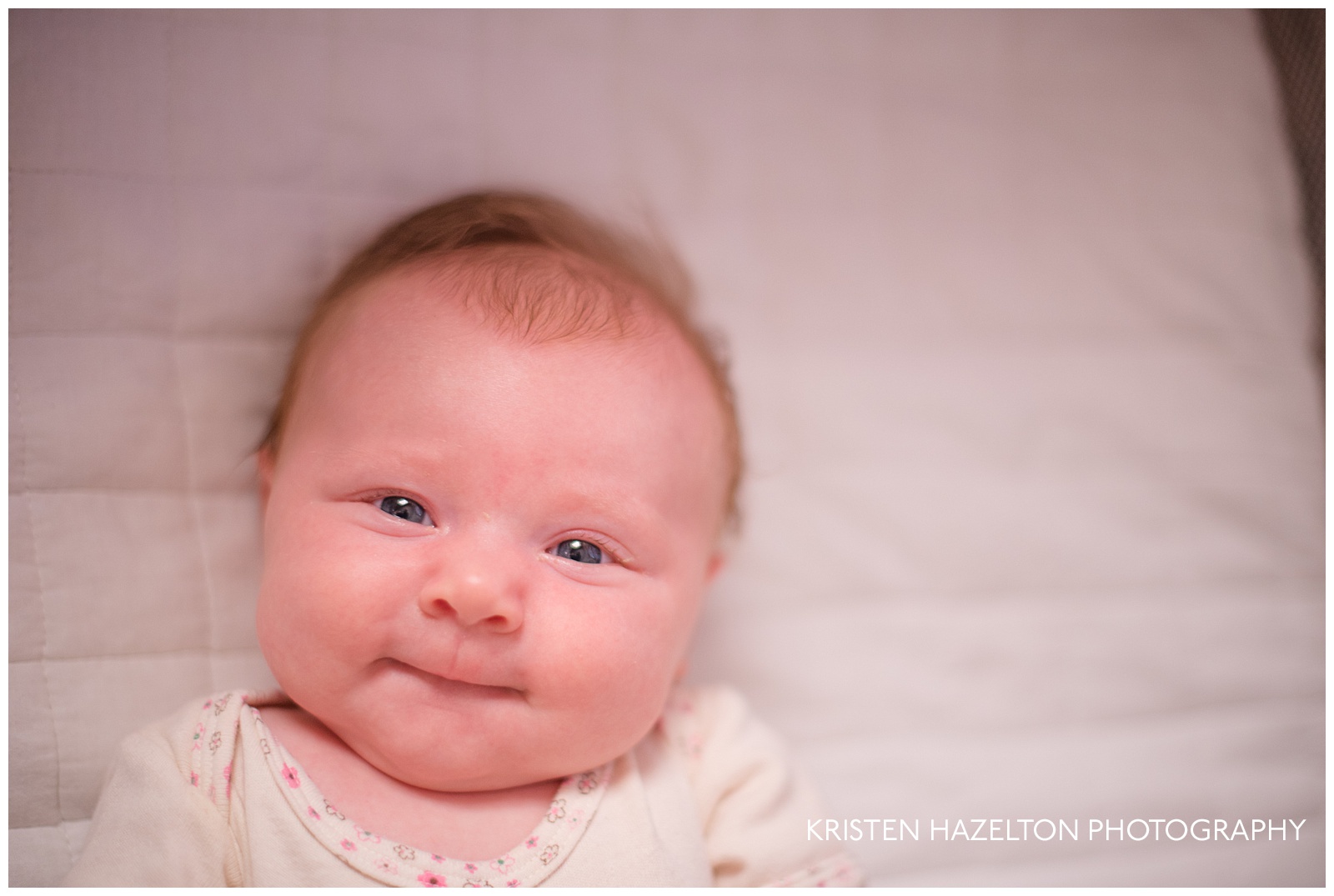 Two month old baby smiling in crib