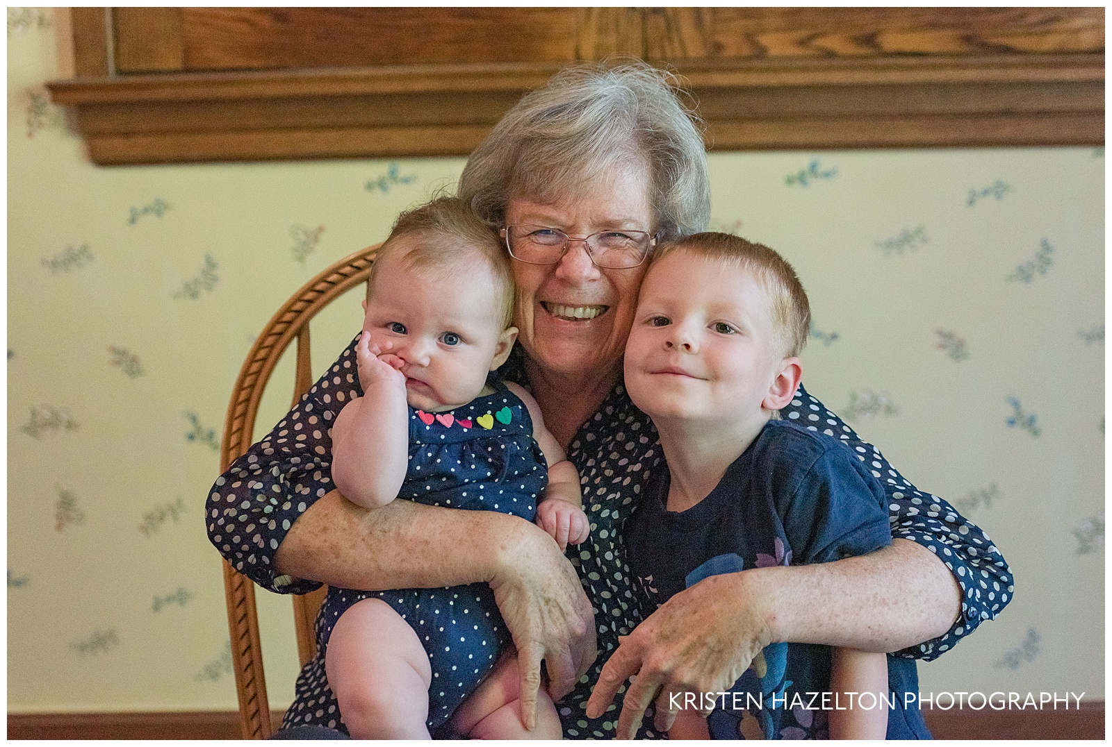 Grandmother hugging her baby granddaughter and young grandson