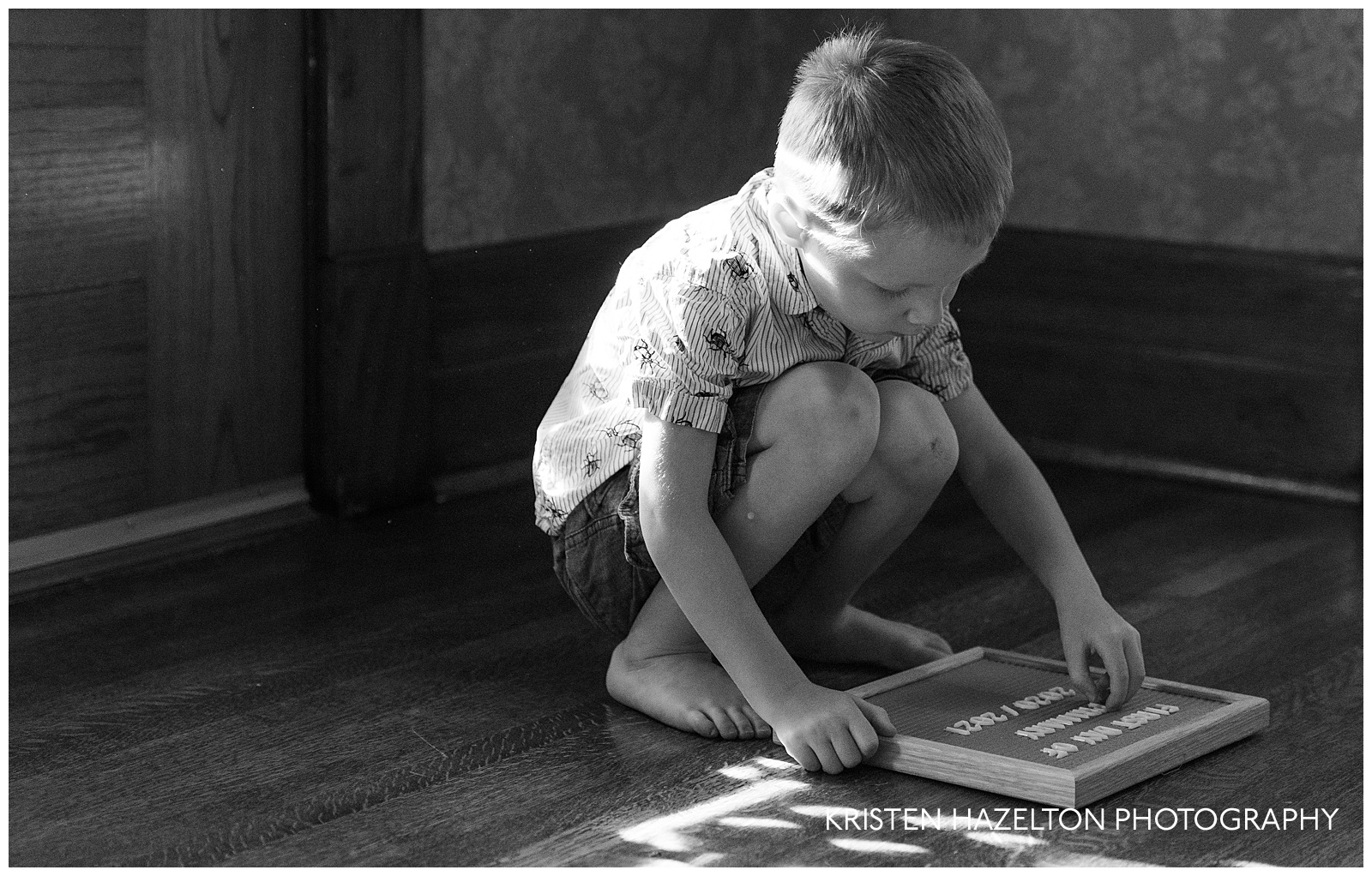 Four year old boy playing with a felt board and letters