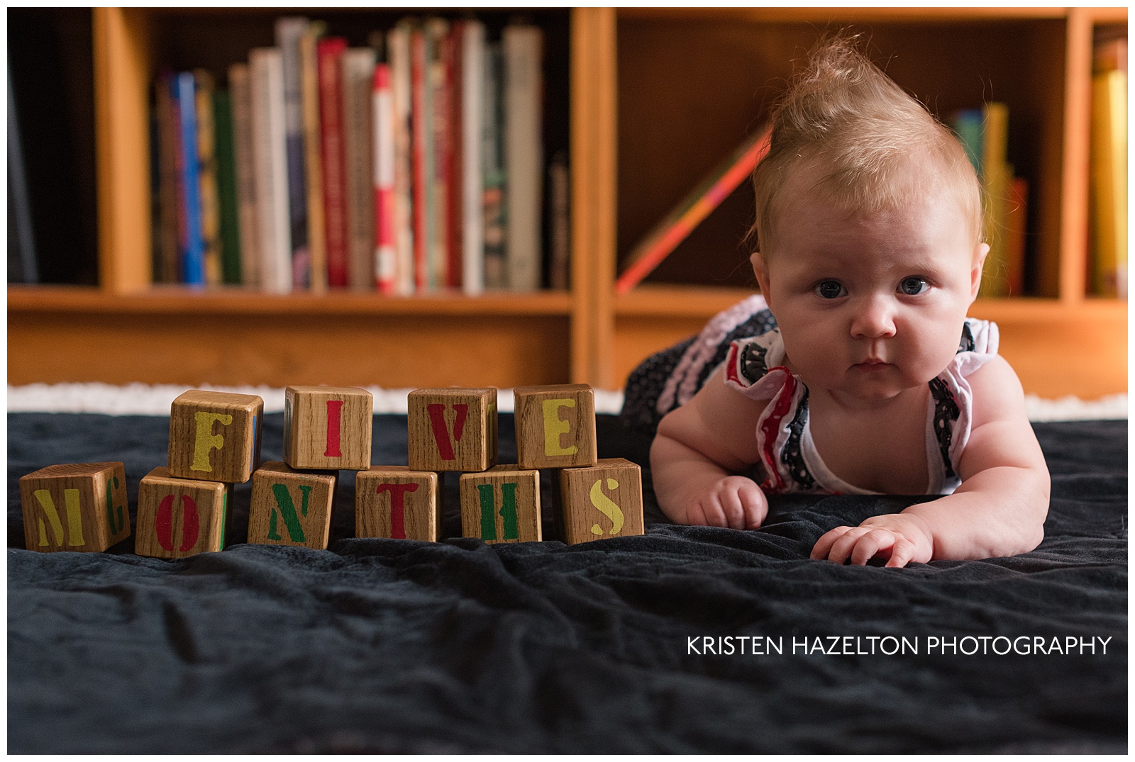 Baby with blocks that read "Five months"