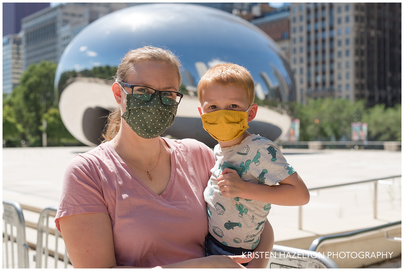 Mother and son wearing surgical masks at the Chicago Cloud Gate "Bean"