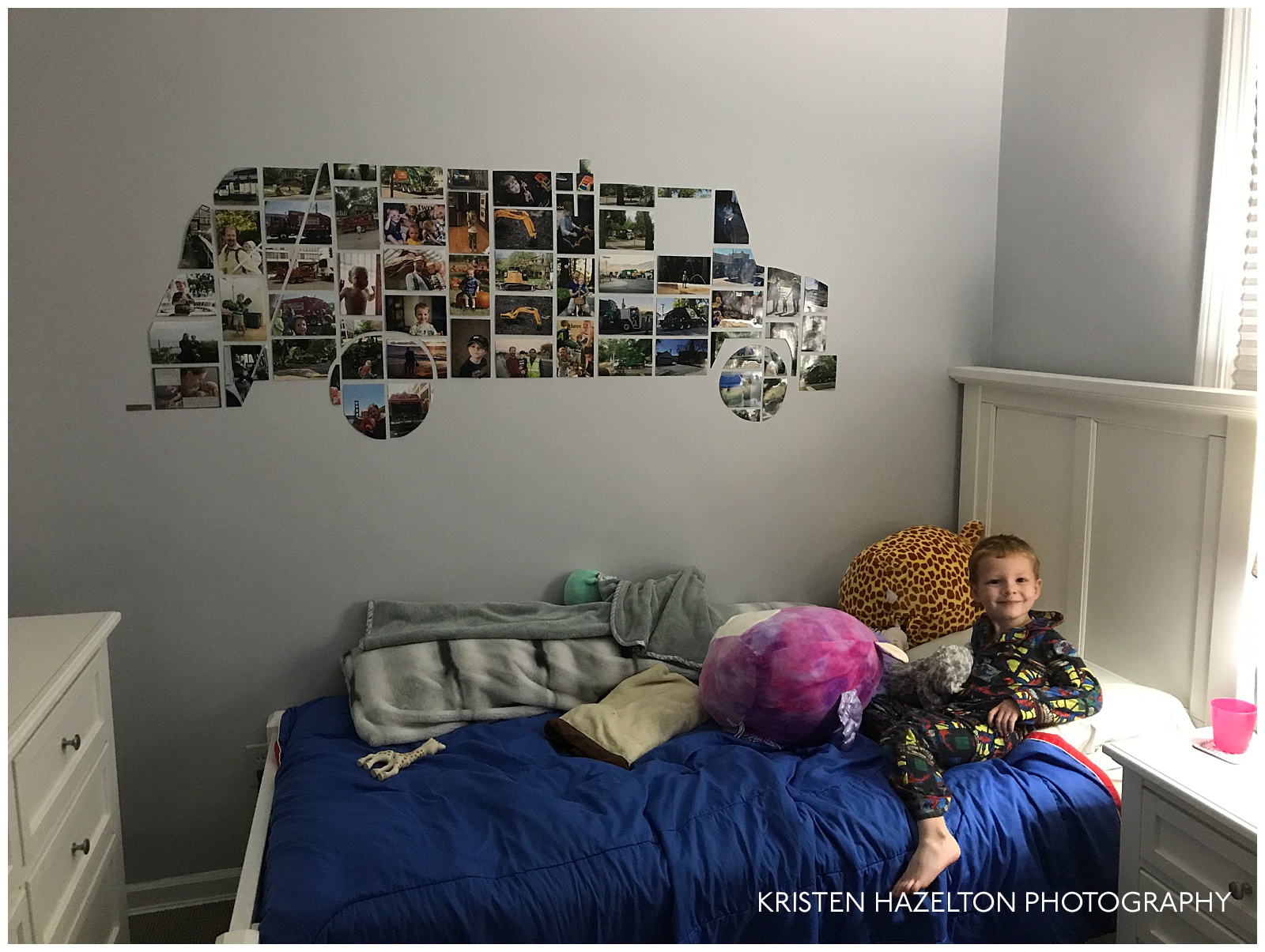 Small boy with a garbage truck mural made of photos of garbage trucks