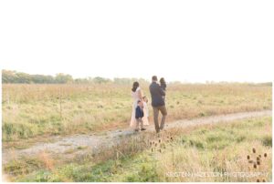 Family portraits at sunrise in a meadow