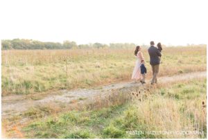 Family of five walking in a meadow
