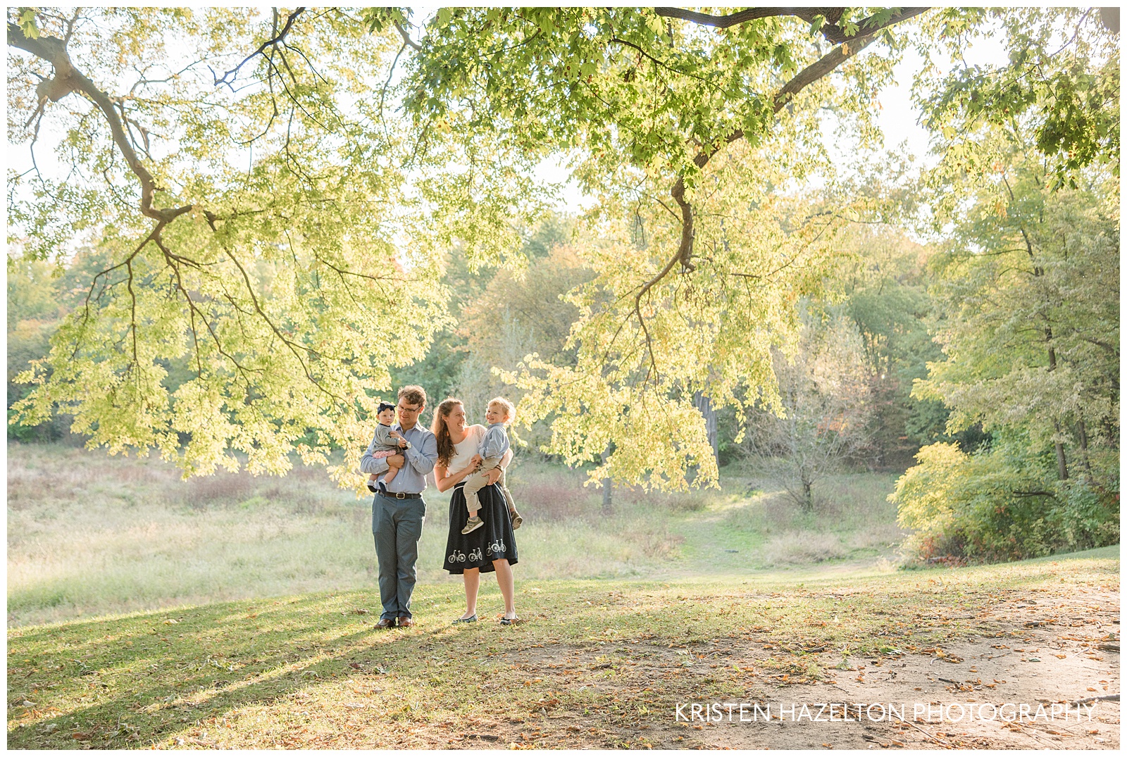 Photo of a Family under a beautiful backlit tree by Oak Park IL family photographer Kristen Hazelton