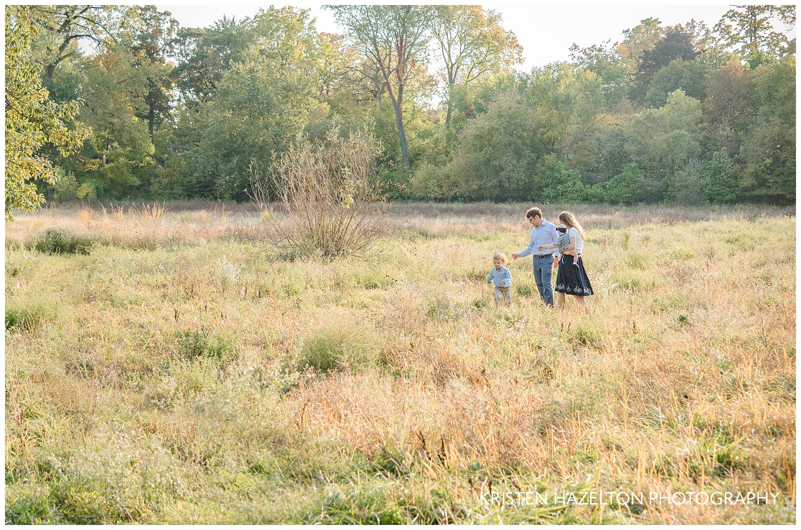 Photo of a Family walking through a field in Riverside, IL by Oak Park IL family photographer Kristen Hazelton