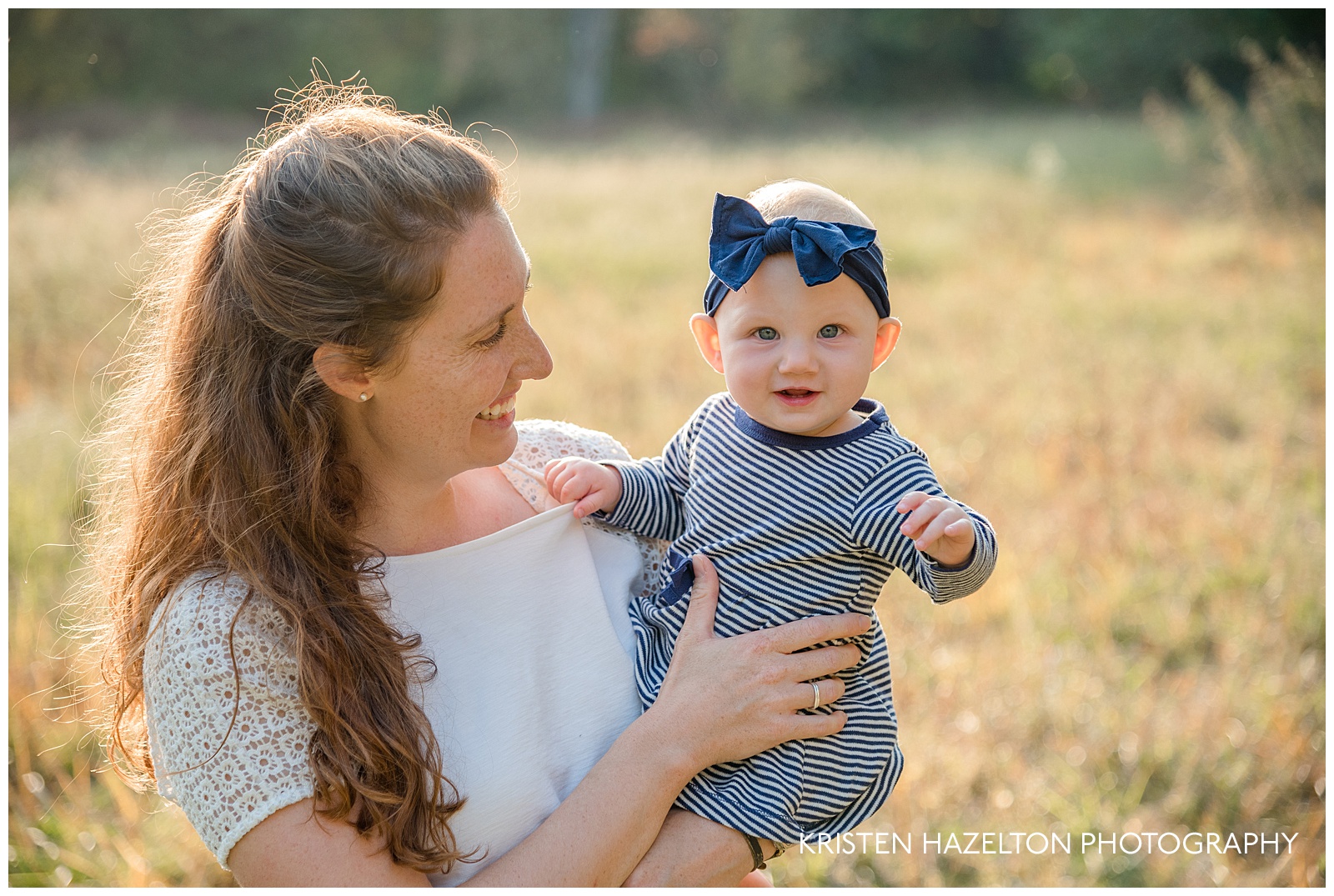 Photo of a Mother holding her baby daughter in a field in Riverside, IL by Oak Park IL family photographer Kristen Hazelton