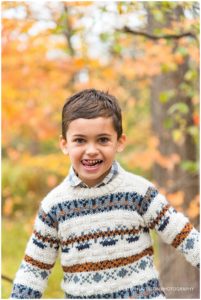 Portrait of a young boy with fall leaves