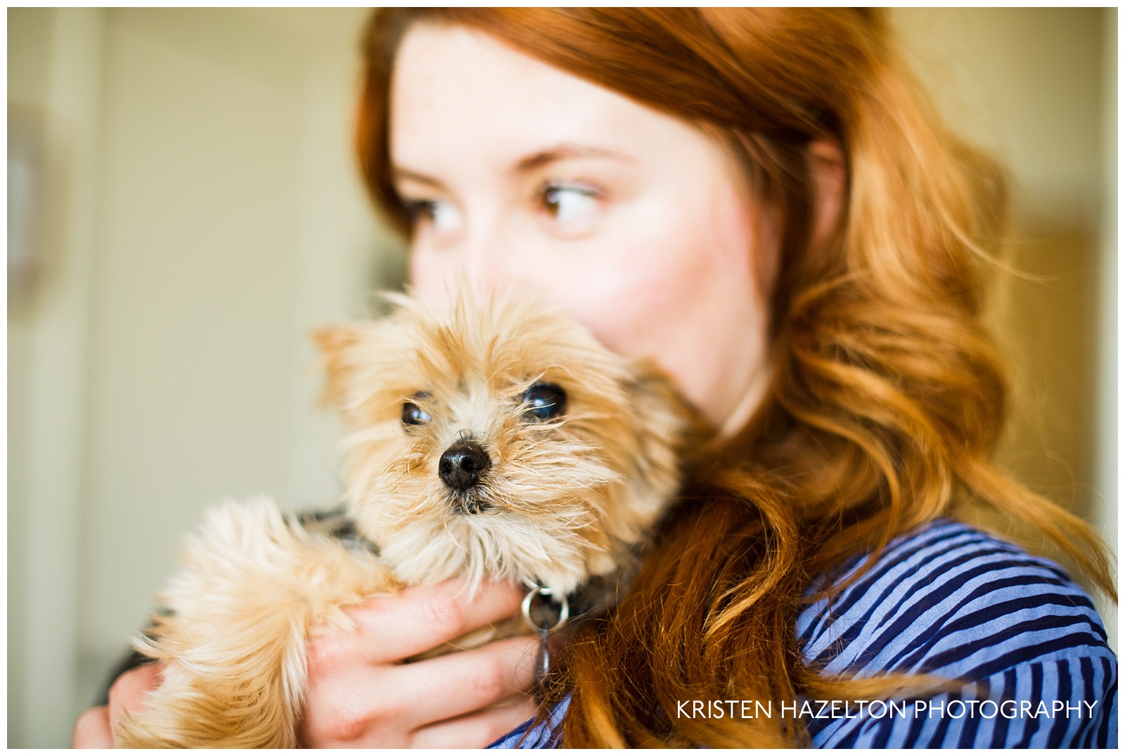 redheaded woman holding a small dog