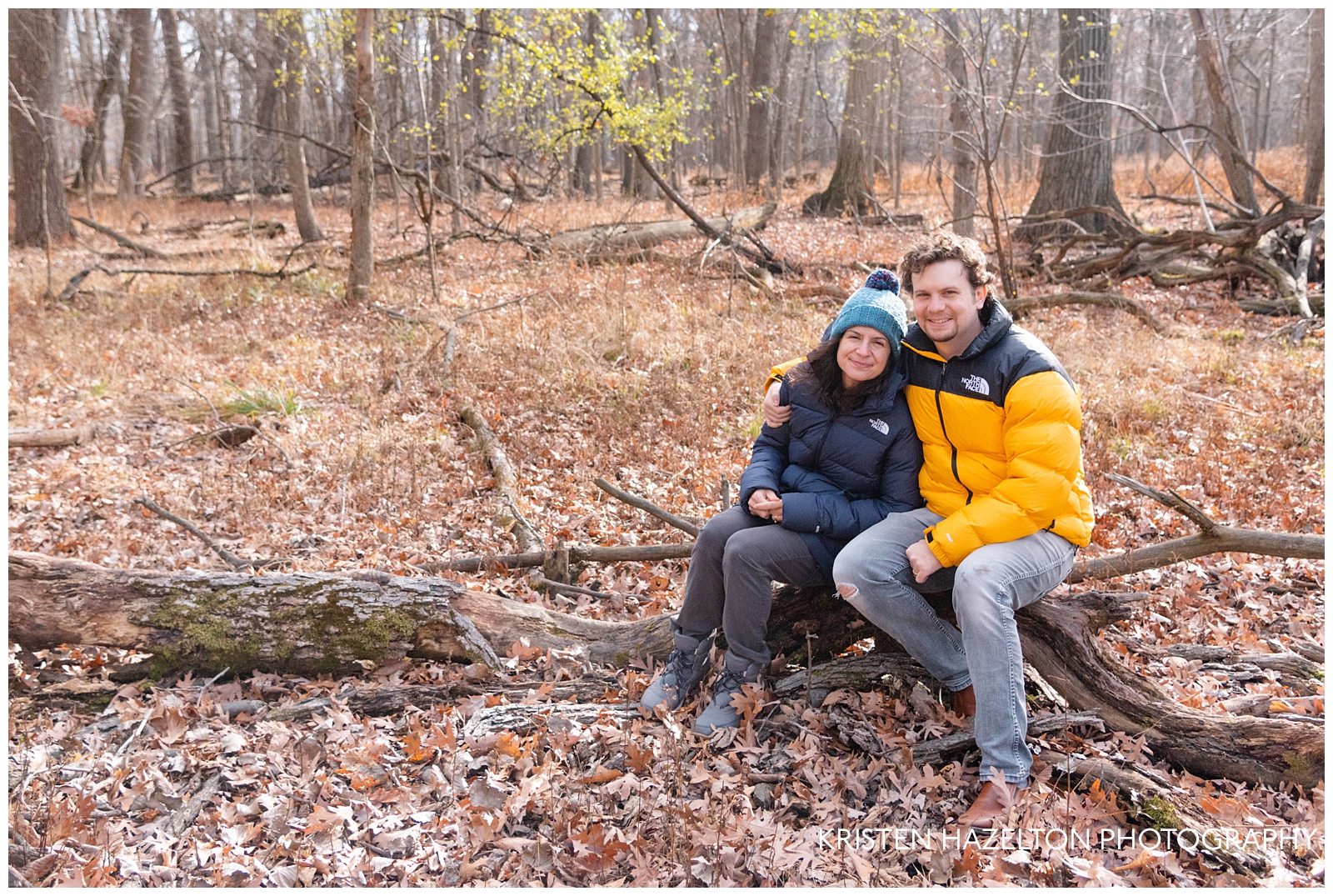 Candid portrait of a young couple in winter jackets in the woods