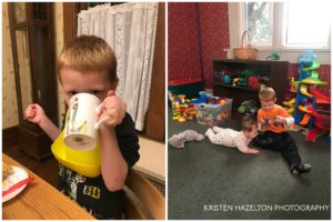 Young boy drinking tea and playing with his baby sister