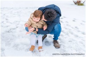 Uncle playing with toddler nephew in the snow
