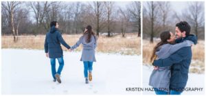 Engaged couple walking in a snowy meadow