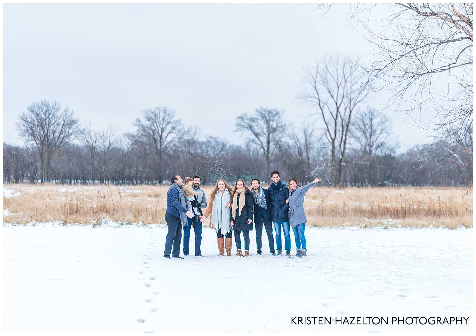 Photo of an extended family throwing snow