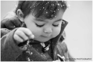 Toddler sprinkling snowflakes