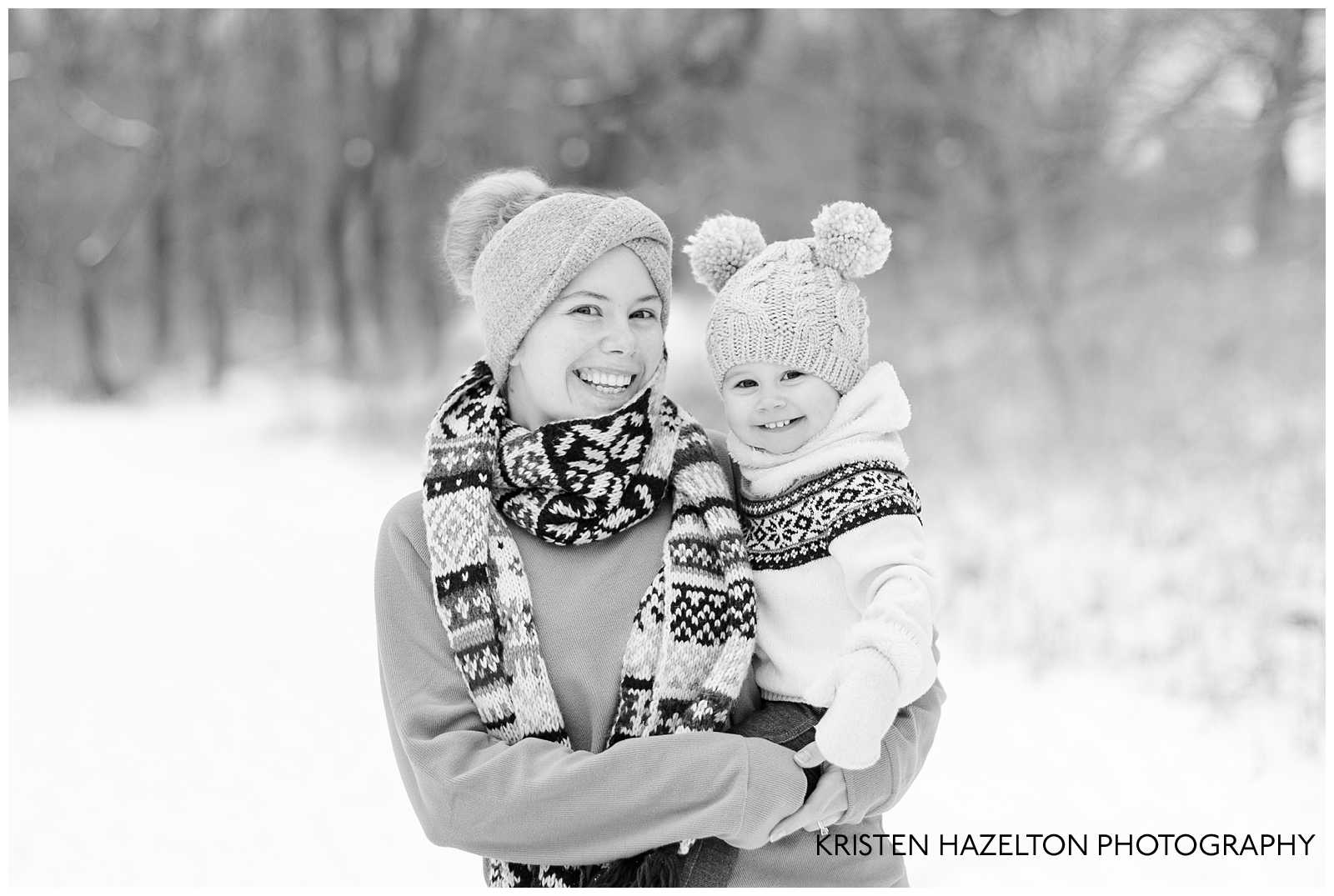 Black and white photo of a mom and daughter wearing snow gear.