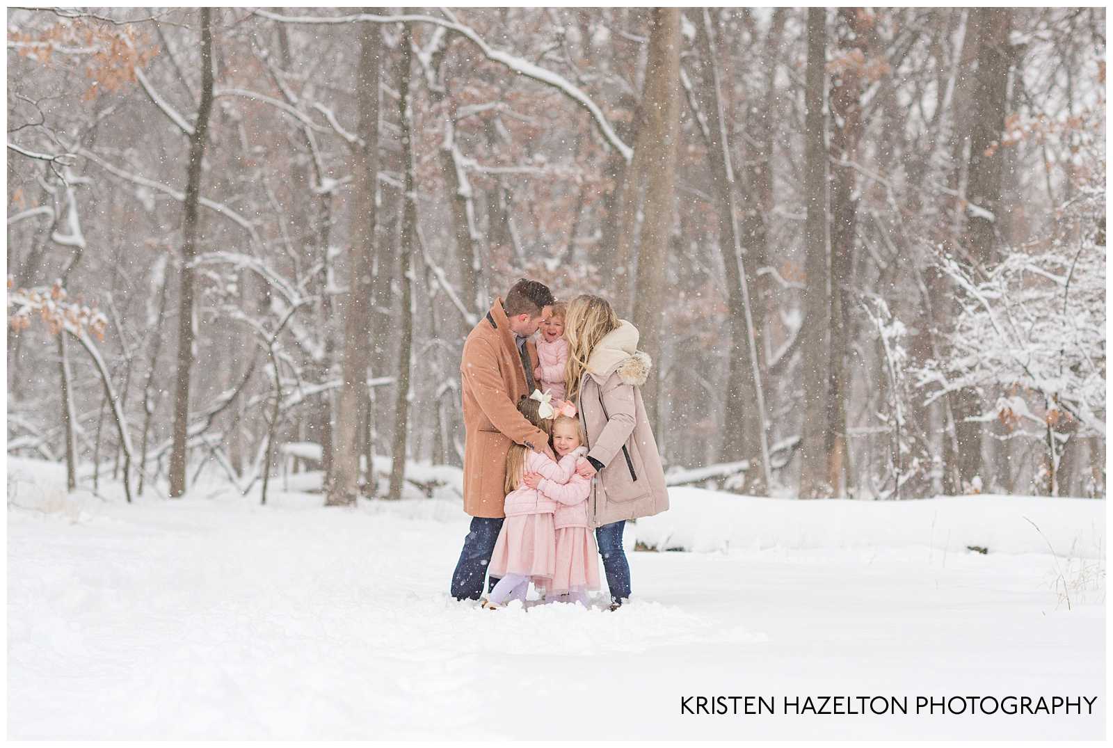 Family tickling daughter at a winter photoshoot
