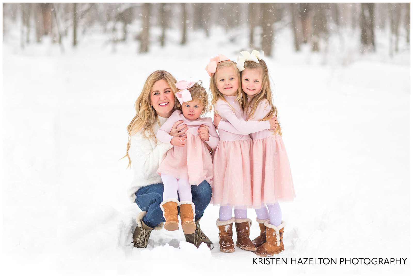 Mom and daughters at a snowfall photoshoot