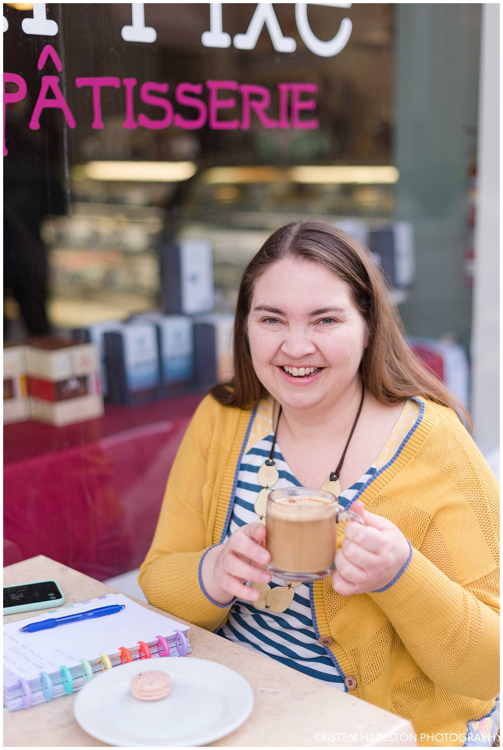Photographer smiling while holding a coffee