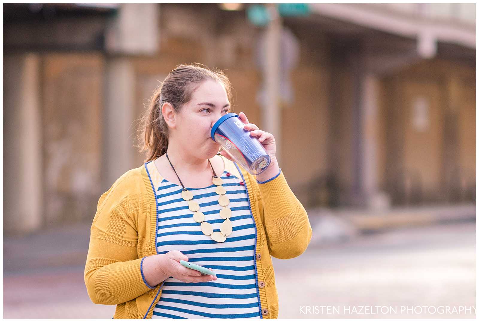 woman in yellow cardigan drinking coffee