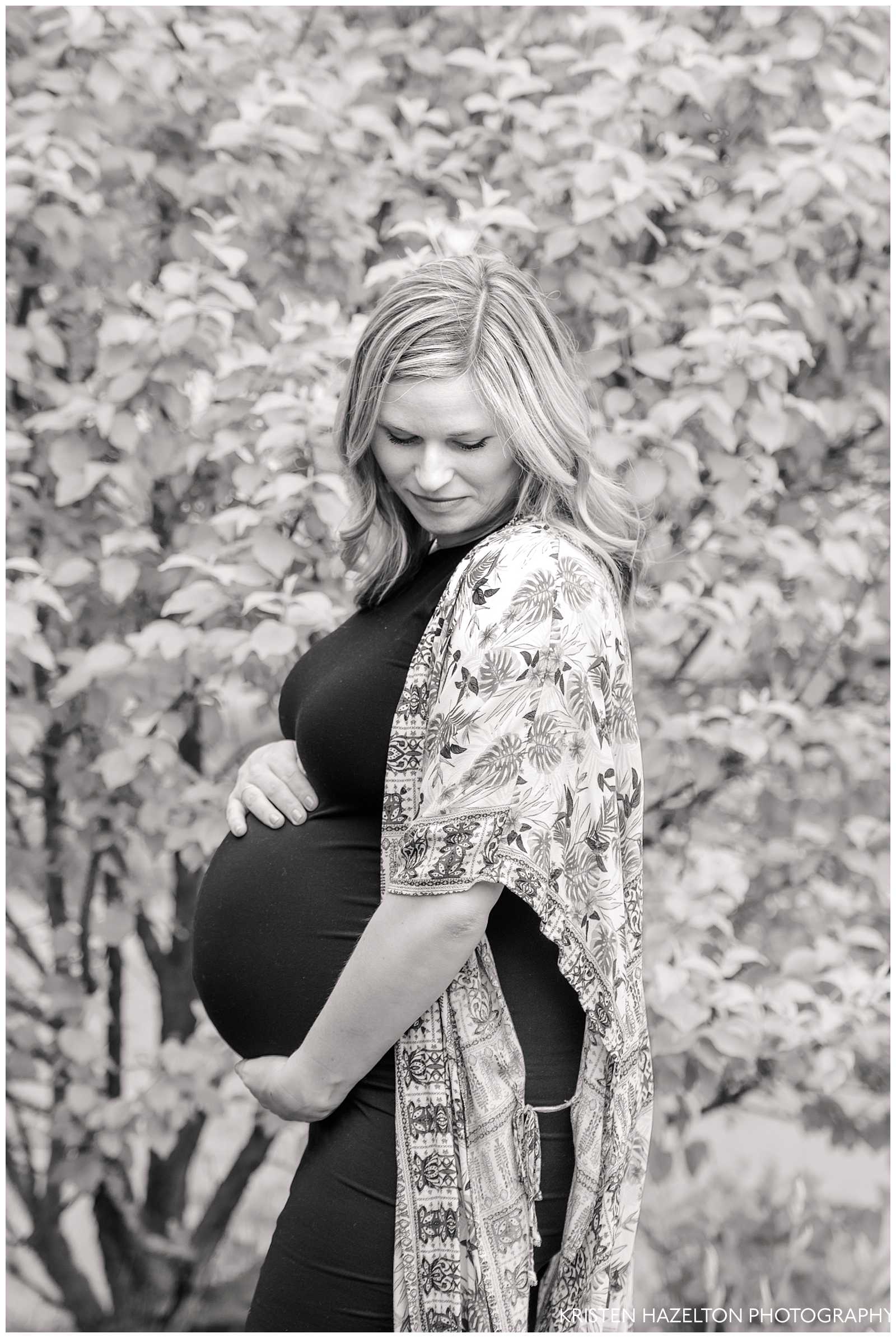 Black and white photo of a 8-month pregnant expecting mother.