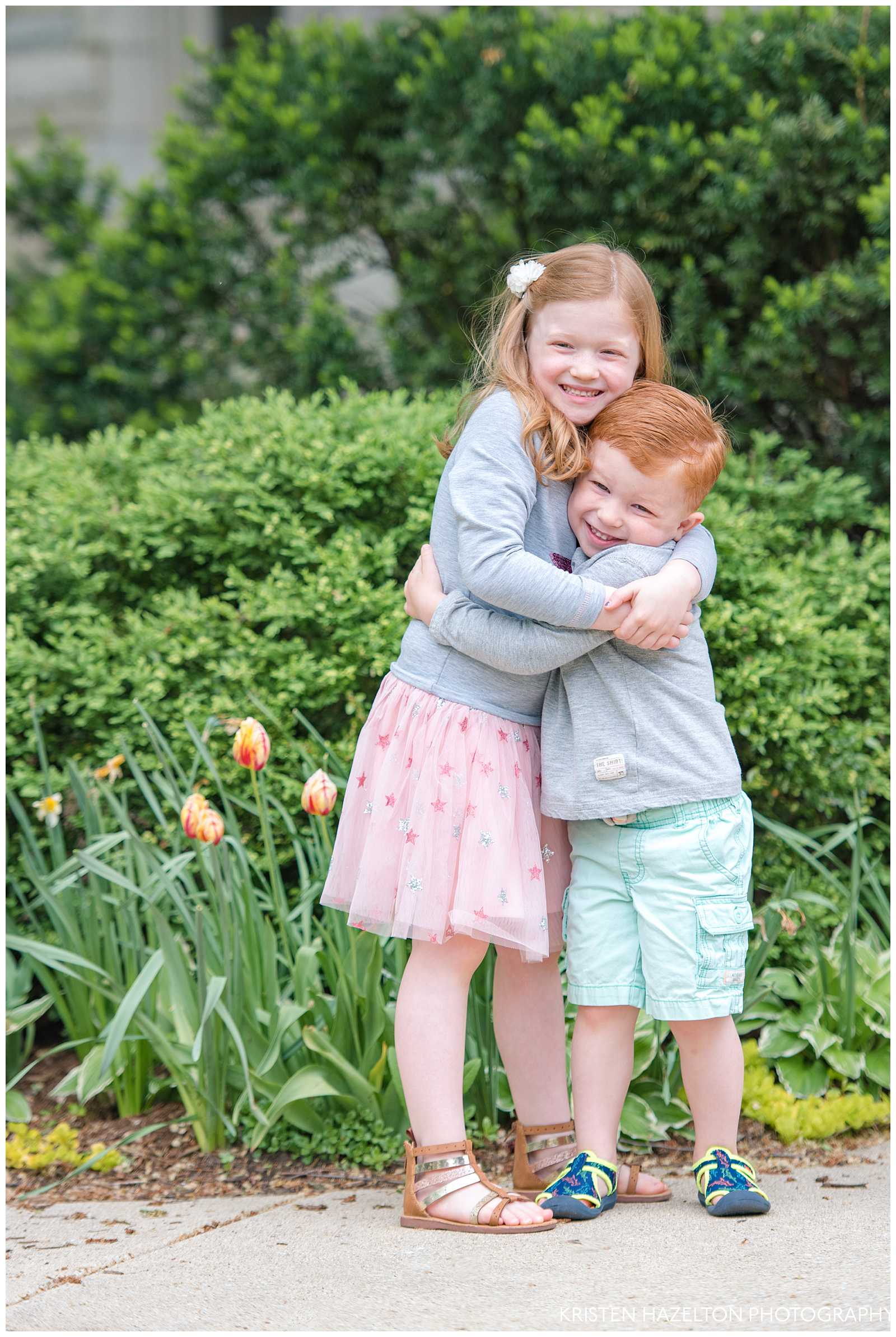 young redheaded sister and brother hugging