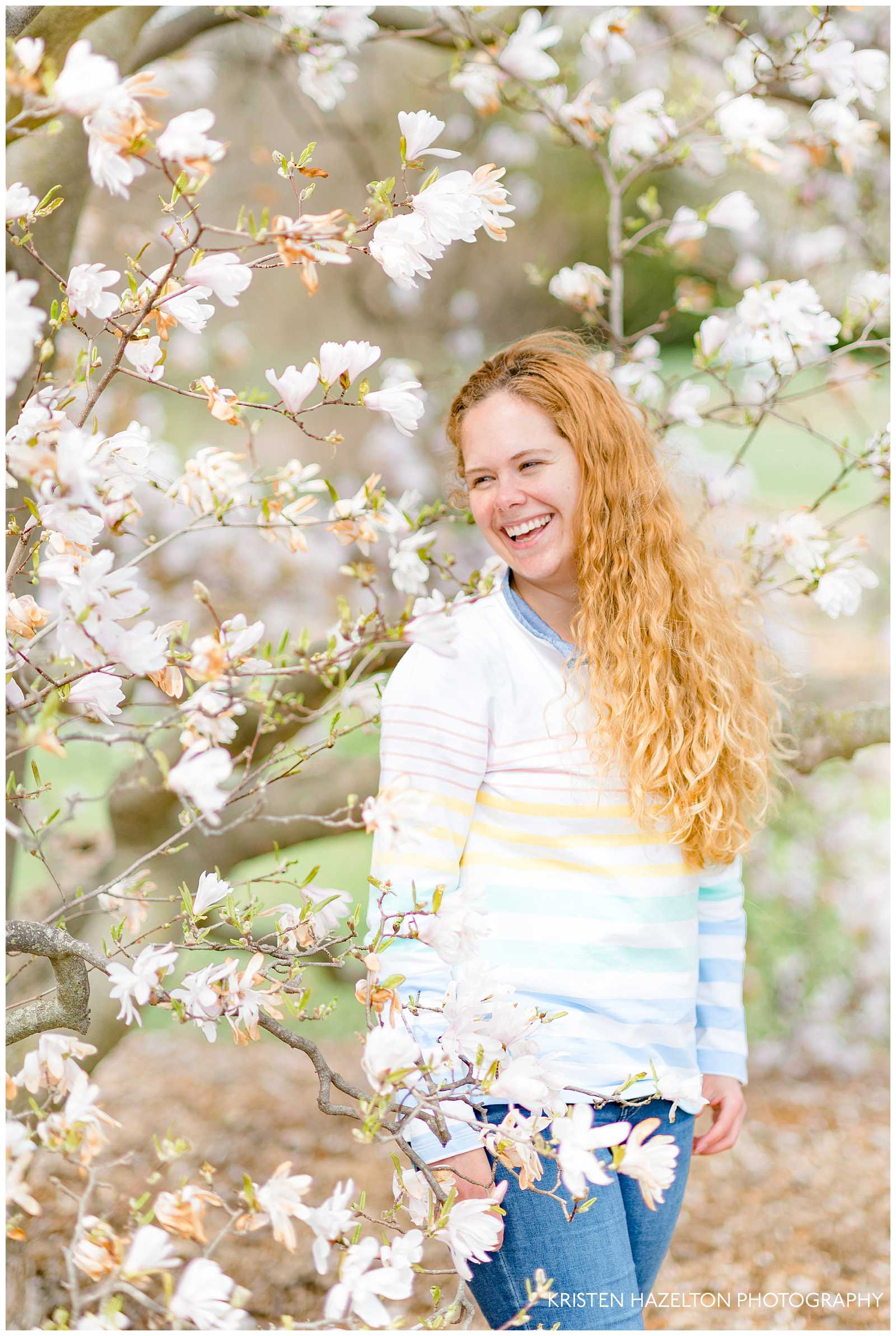 Portrait of a woman smiling in front of star magnolias at the Morton Arboretum