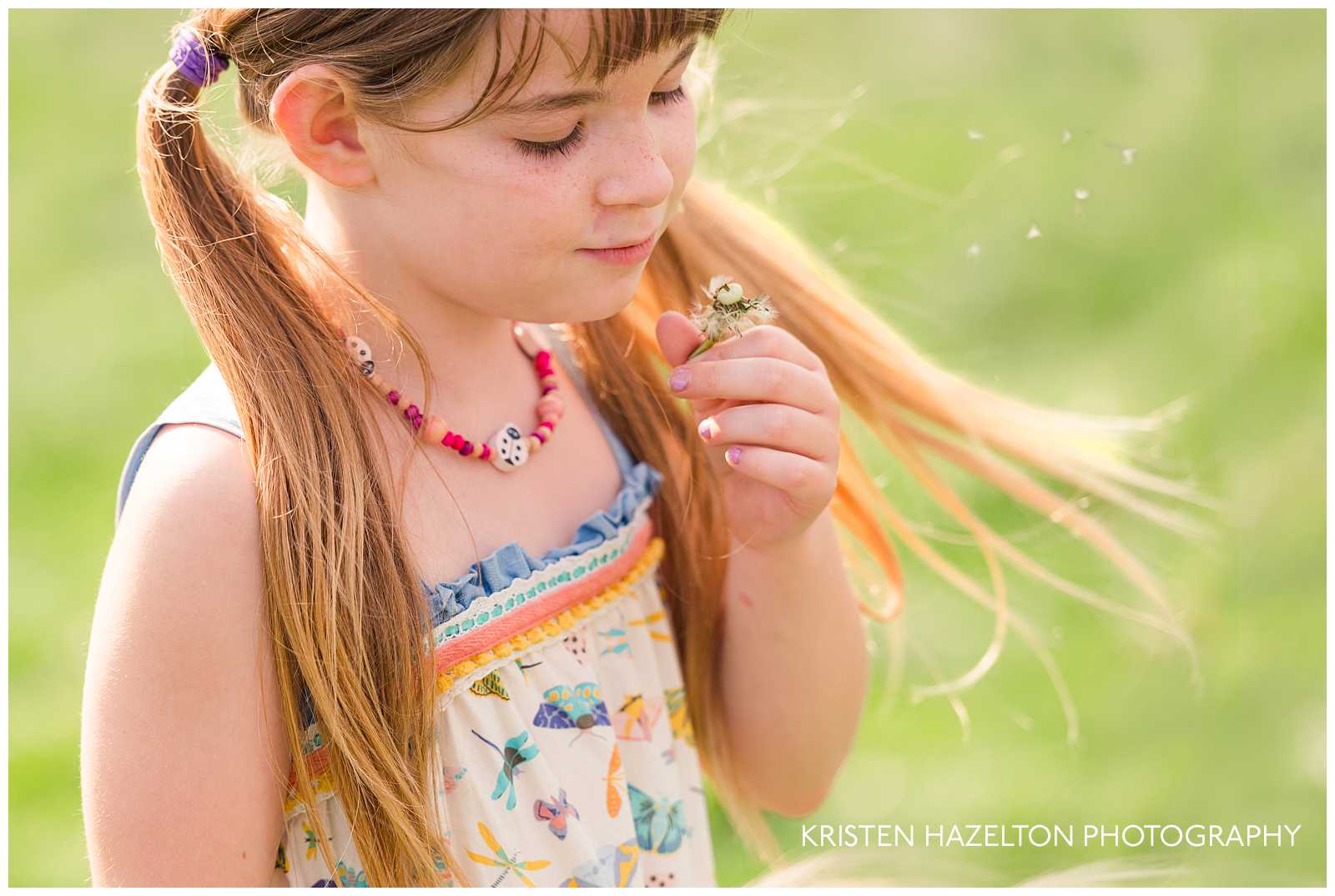 young girl watching dandelion seeds fly away