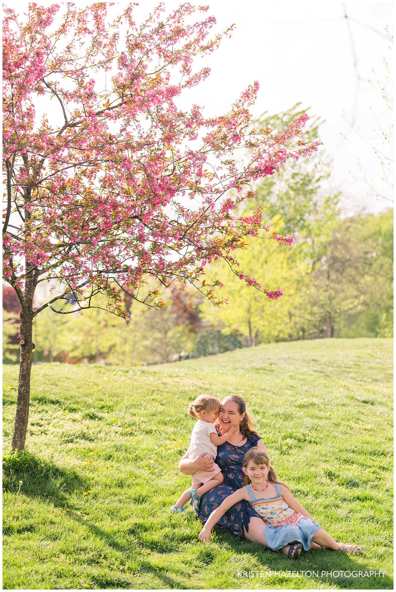 Euclid Square Park family photos of a mother and her two daughters under the pink crabapple blossoms