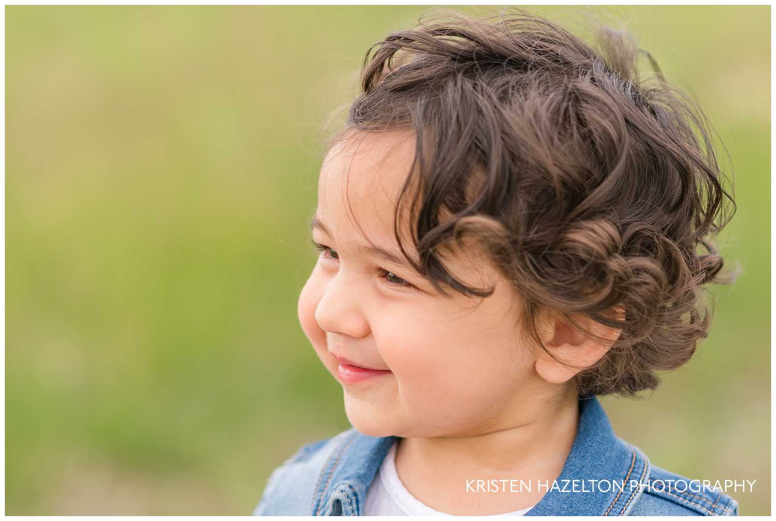 Toddler girl with brown curly hair by Forest Park, IL photographer Kristen Hazelton