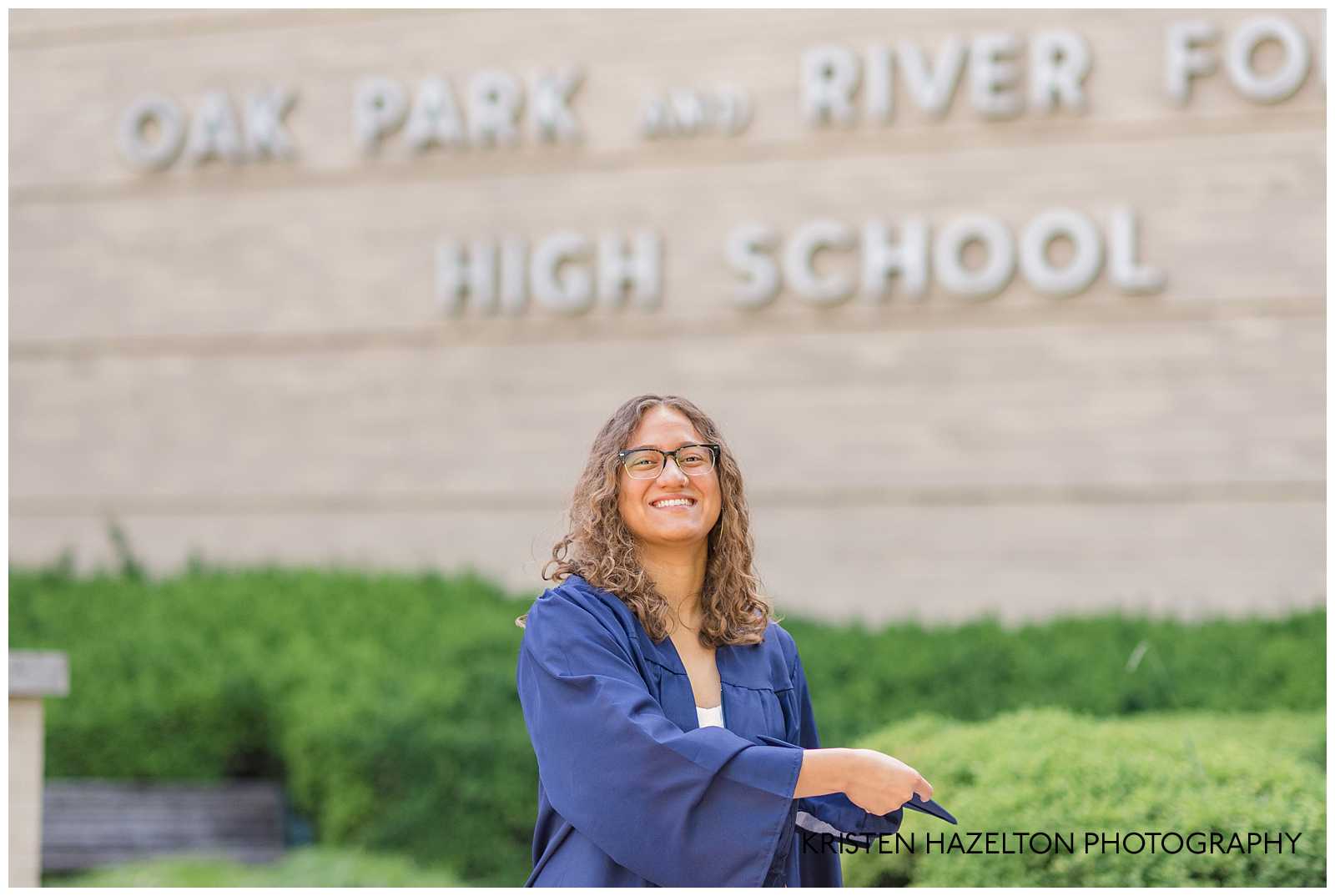 OPRFHS senior about to throw her cap during a graduation cap and gown photoshoot