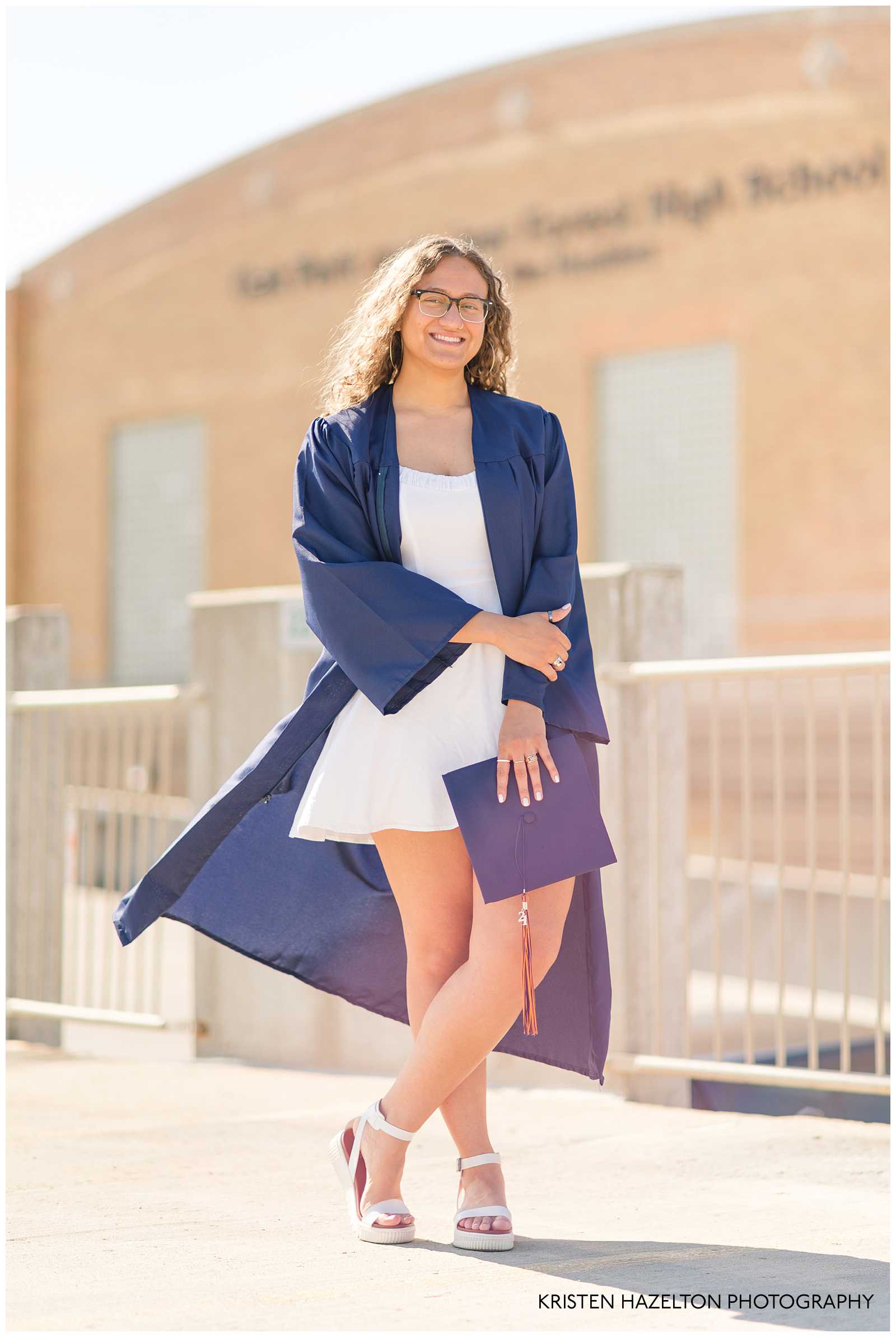 OPRFHS Senior Photos of a female graduate wearing her gown and holding her cap