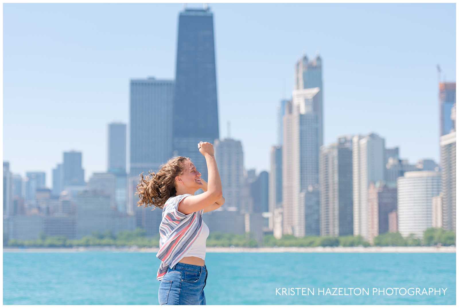 High school senior girl with hair blowing in the wind at Chicago's North Avenue Beach