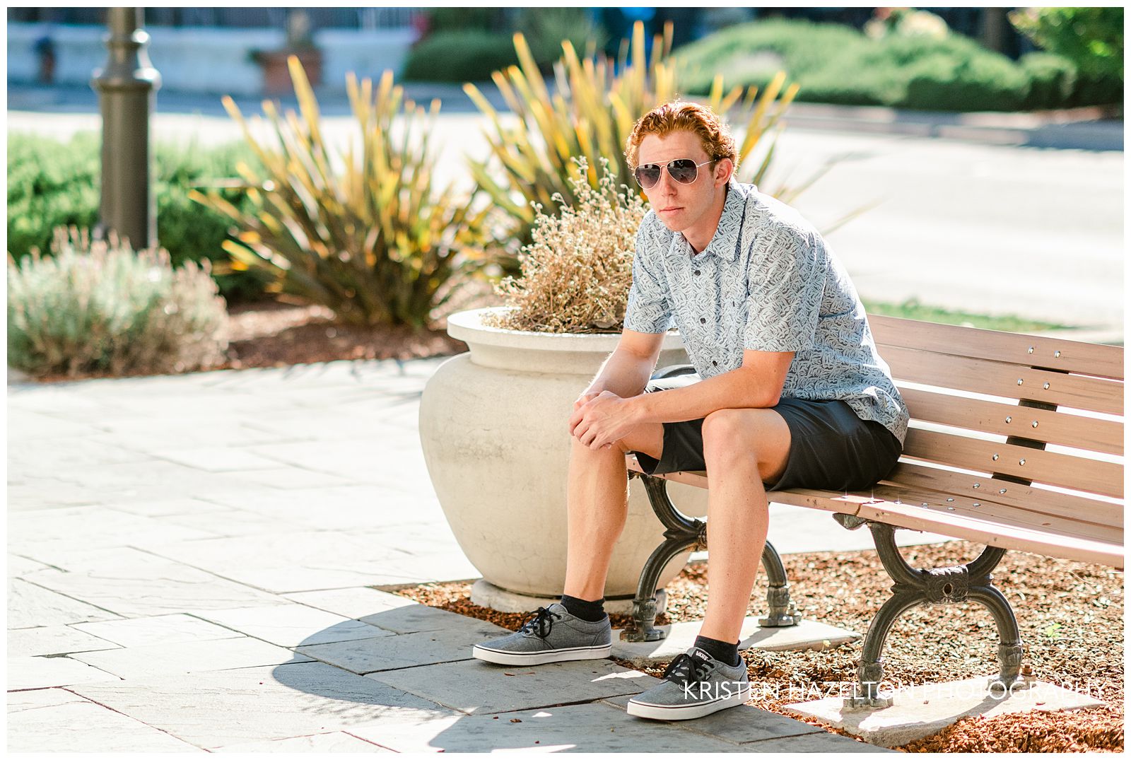 High school senior guy seated on a bench for his downtown Livermore photos
