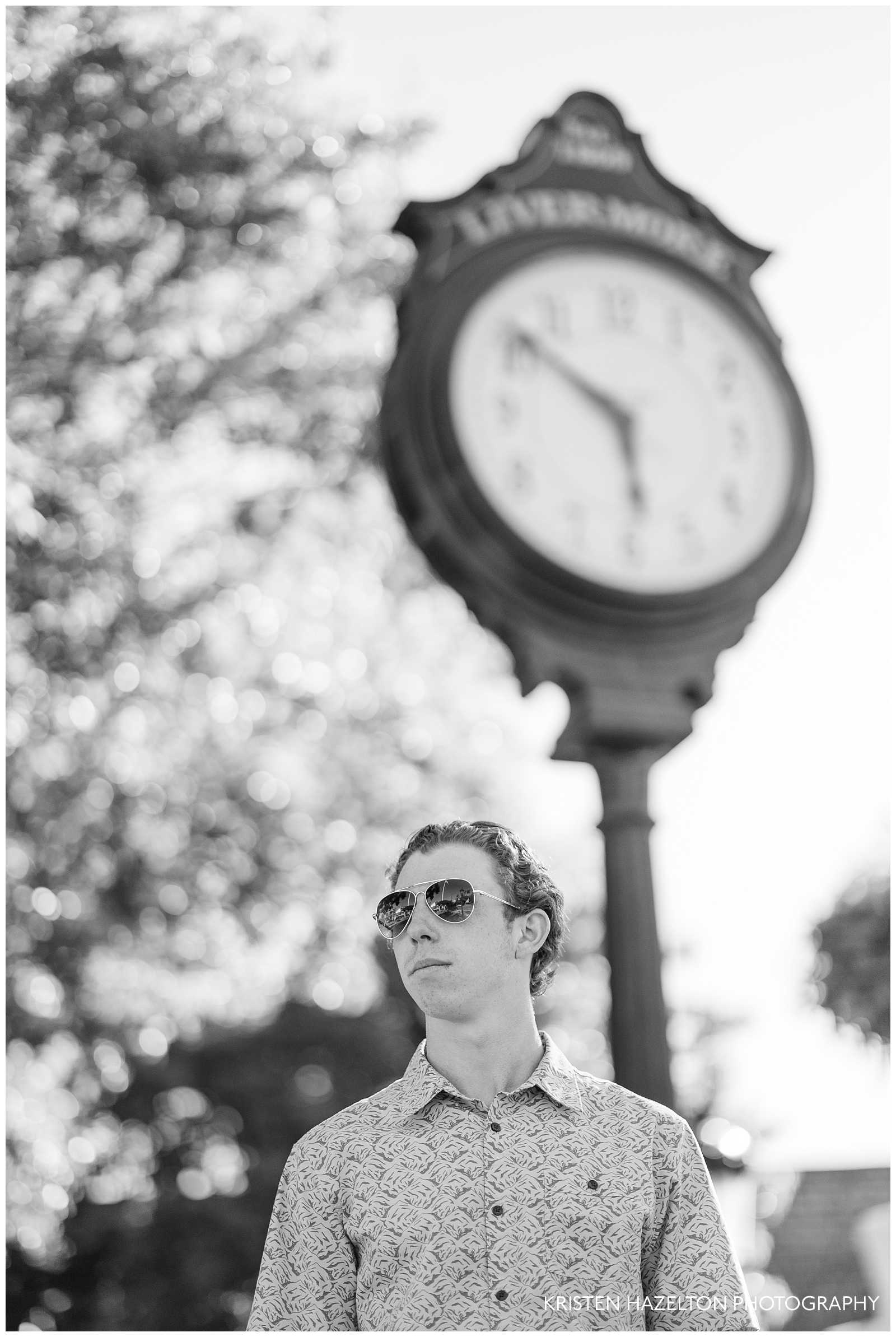 Male high school senior portraits in downtown with a clock in the background