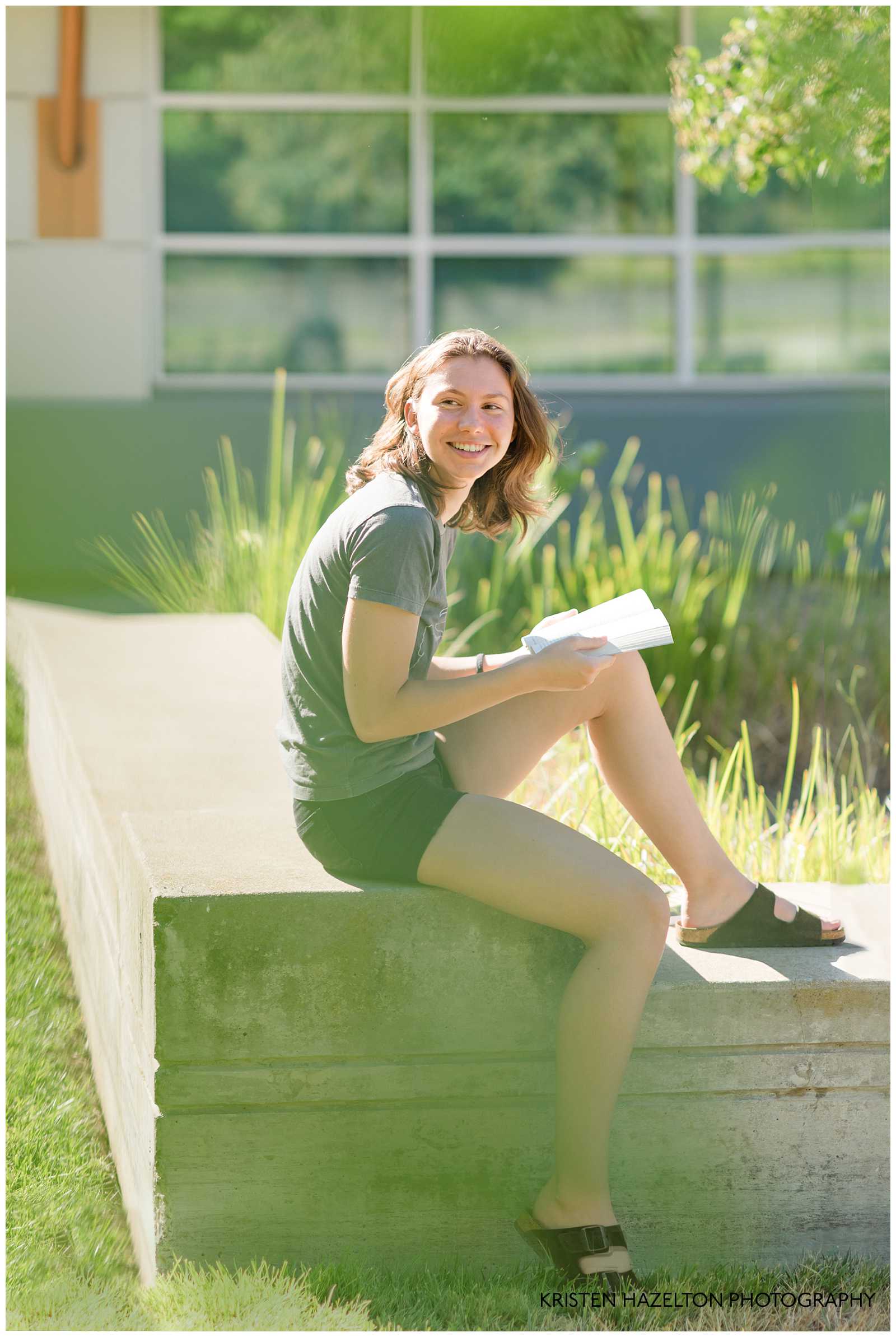 High school senior portrait of a girl reading a book at the Livermore Civic Center