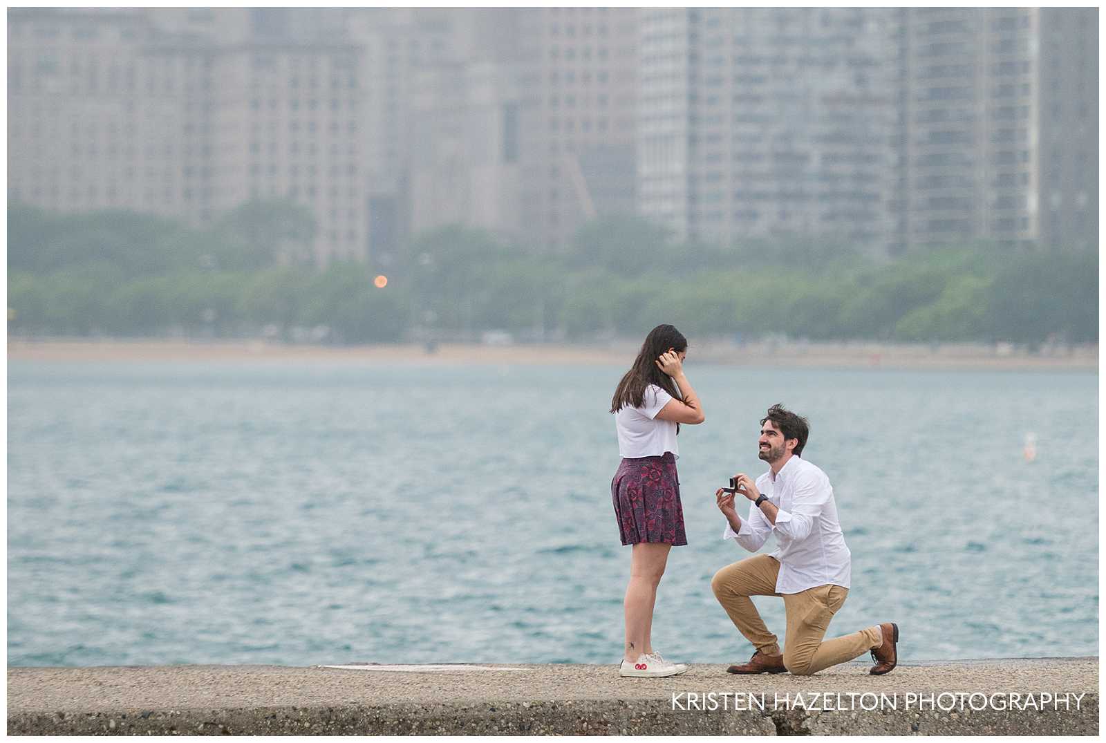 Man kneeling to propose at North Avenue Beach