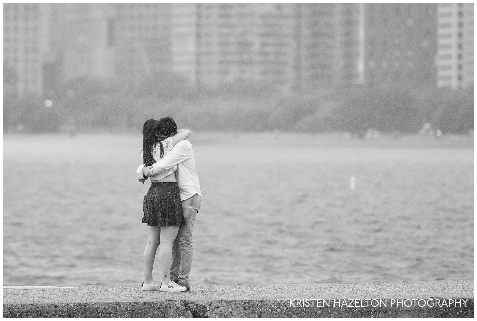 Man hugging his new fiancee during a rainstorm