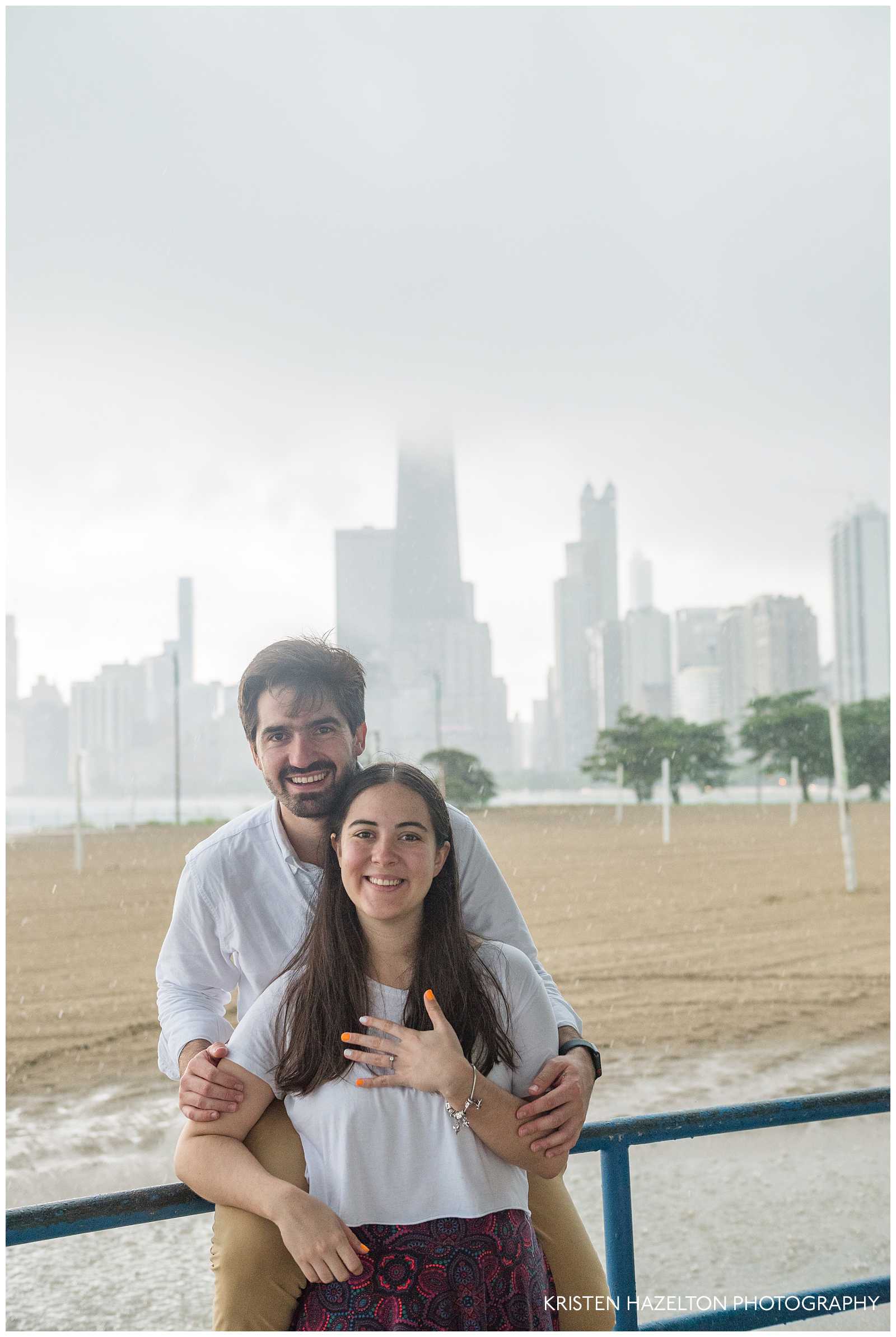 Newly engaged couple at North Avenue Beach during severe rainstorm