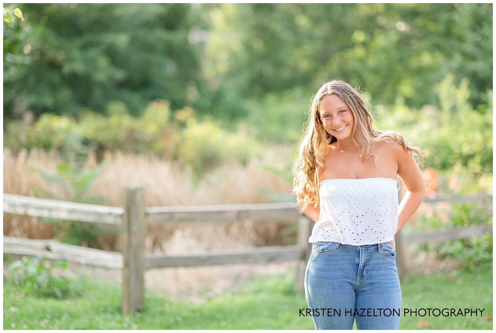 High school senior girl wearing jeans and a white top for her OPRF Senior Pictures 