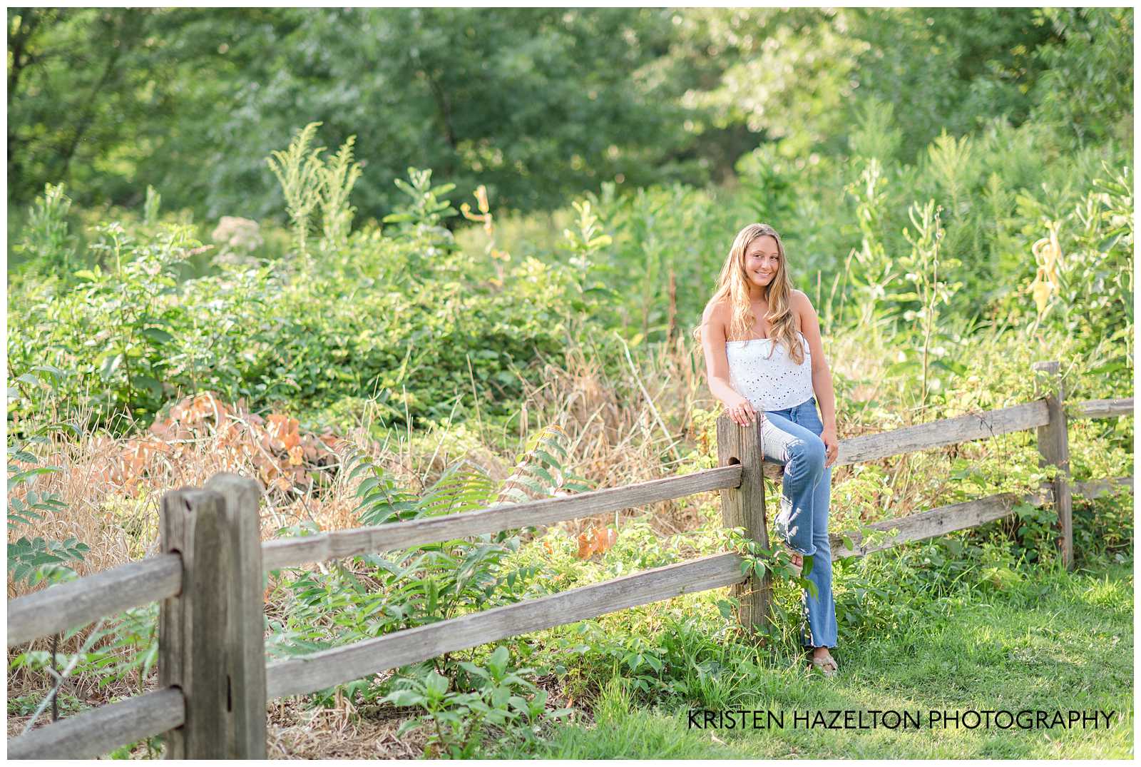 High school senior girl sitting on a fence for her OPRF Senior Pictures 