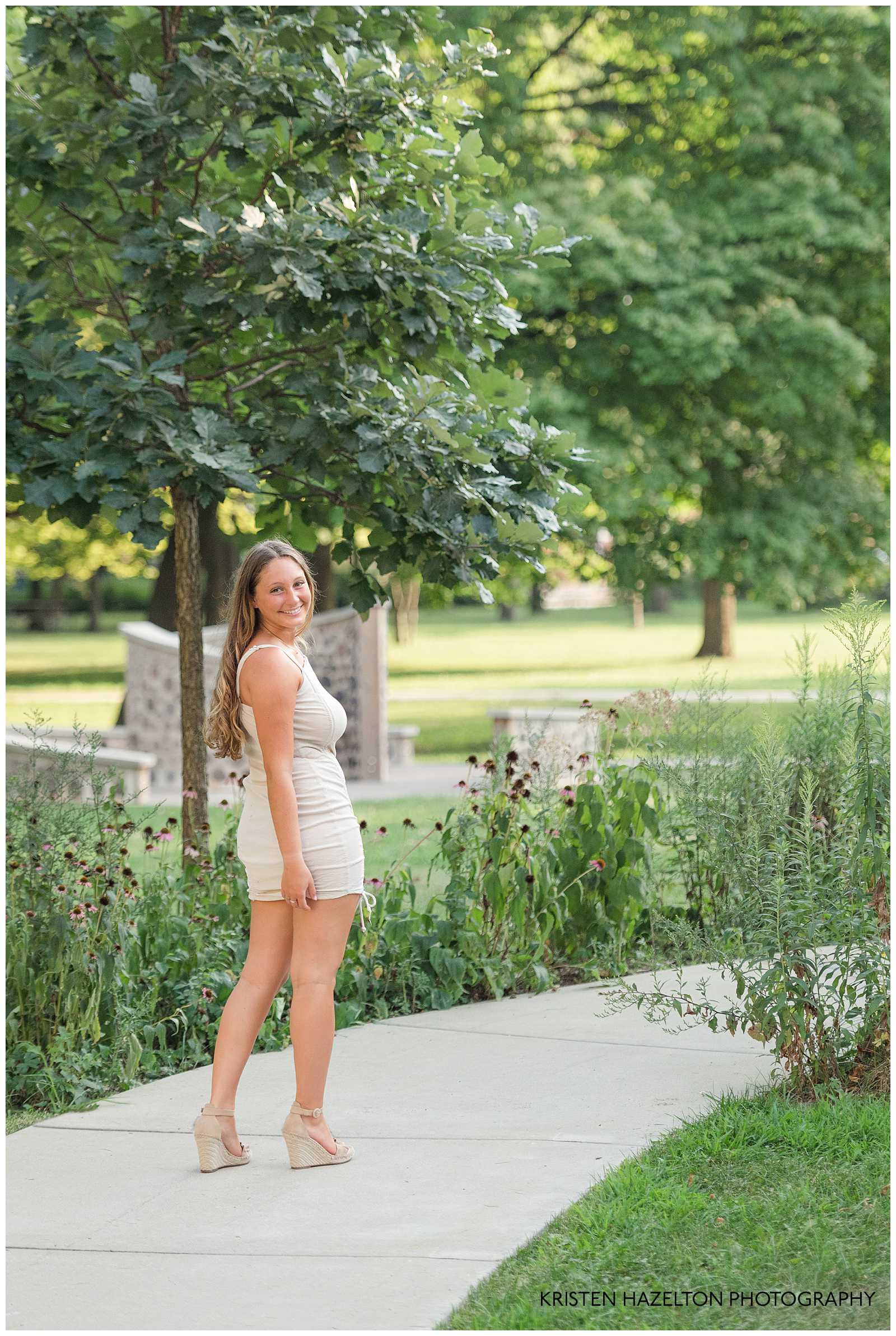 Senior girl wearing white and turning back towards the camera for her OPRF Senior Pictures 