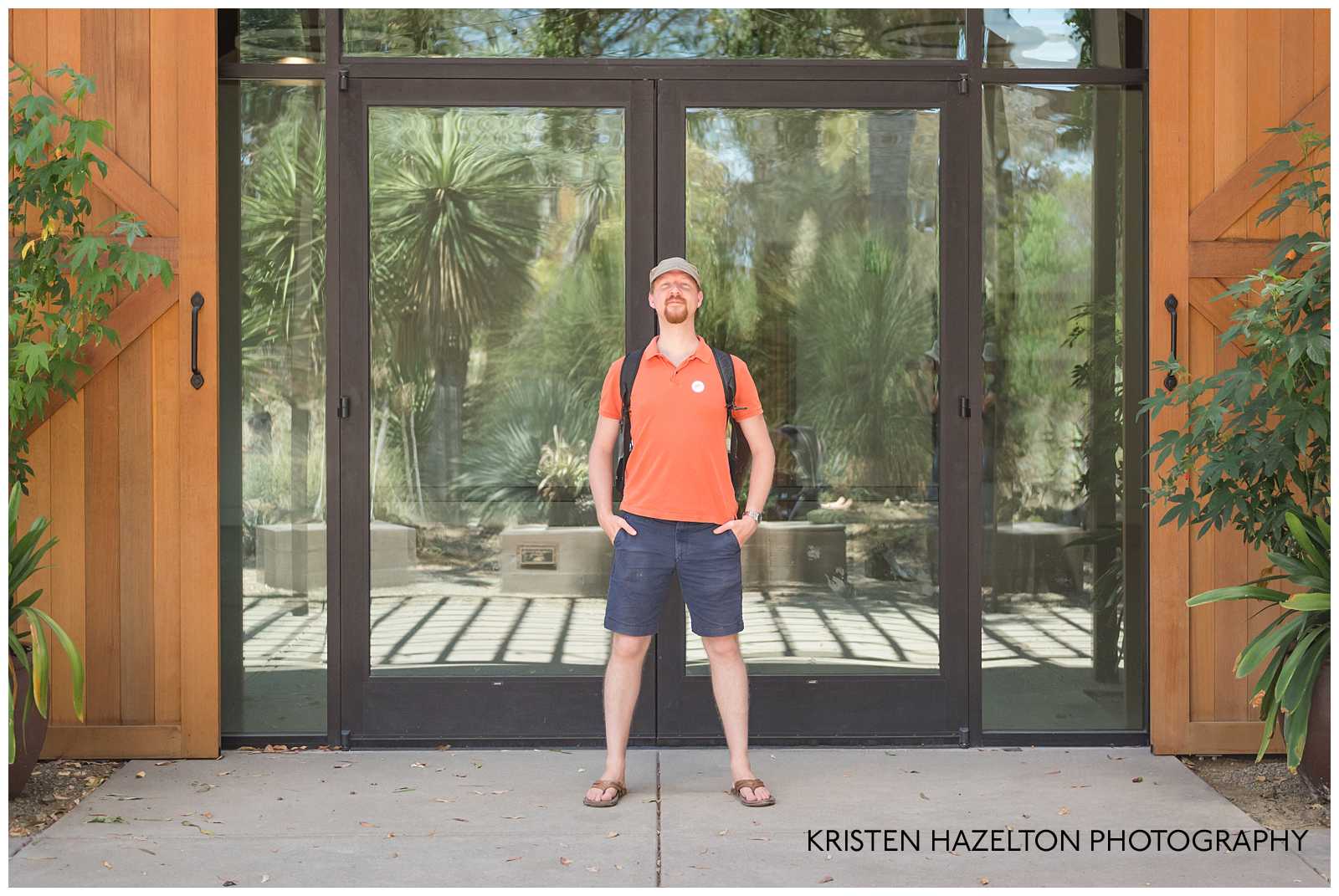 Man in orange shirt standing in front of two glass doors at the Ruth Bancroft Garden