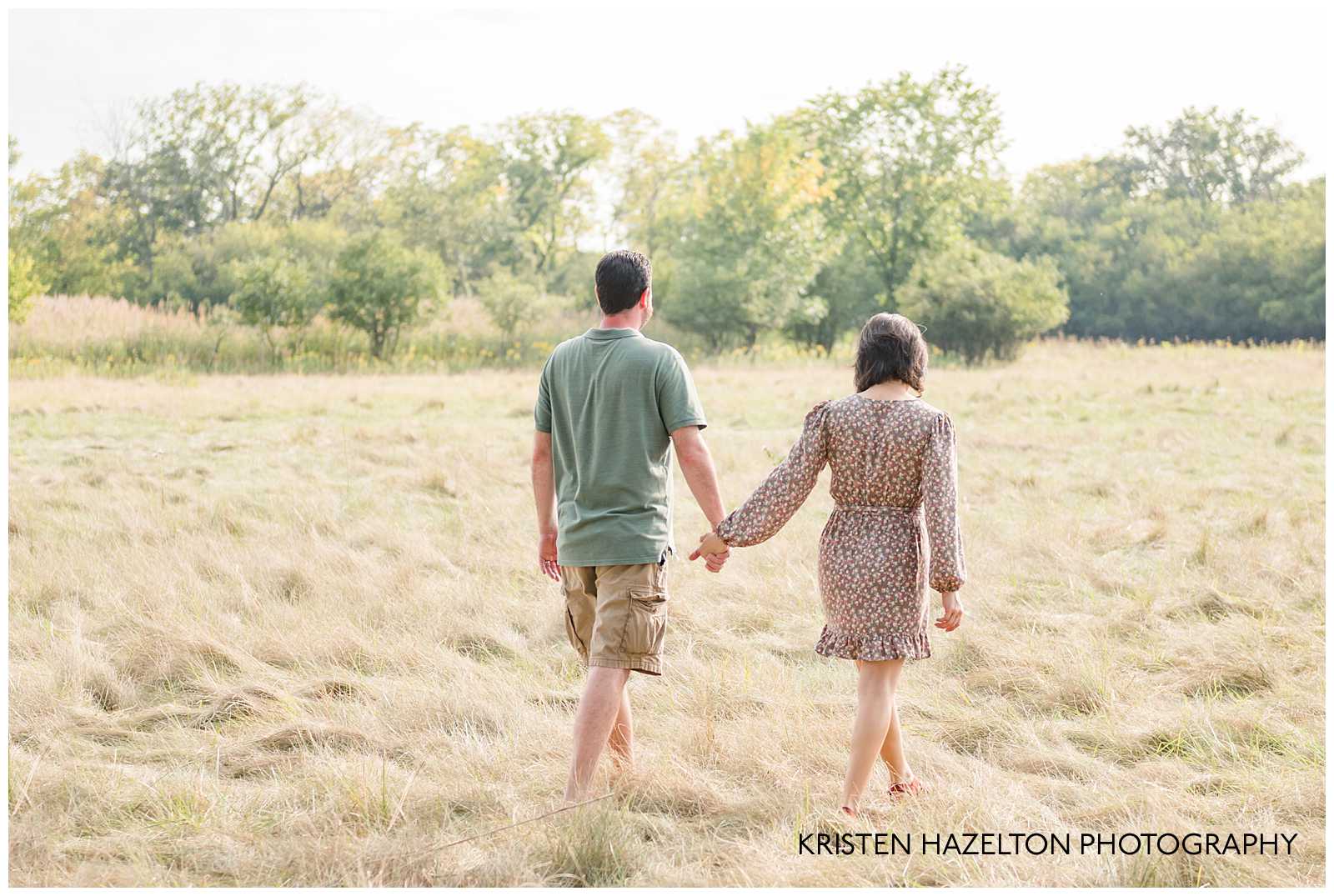 Husband and wife walking together in a field