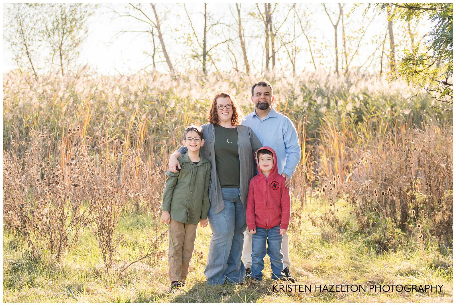 Family of four in a field with cattails by Oak Park, IL and Brookfield IL photographer Kristen Hazelton